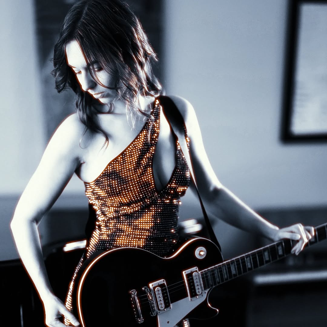 Awake & Dreaming Sasha Kristoff posing with guitar
